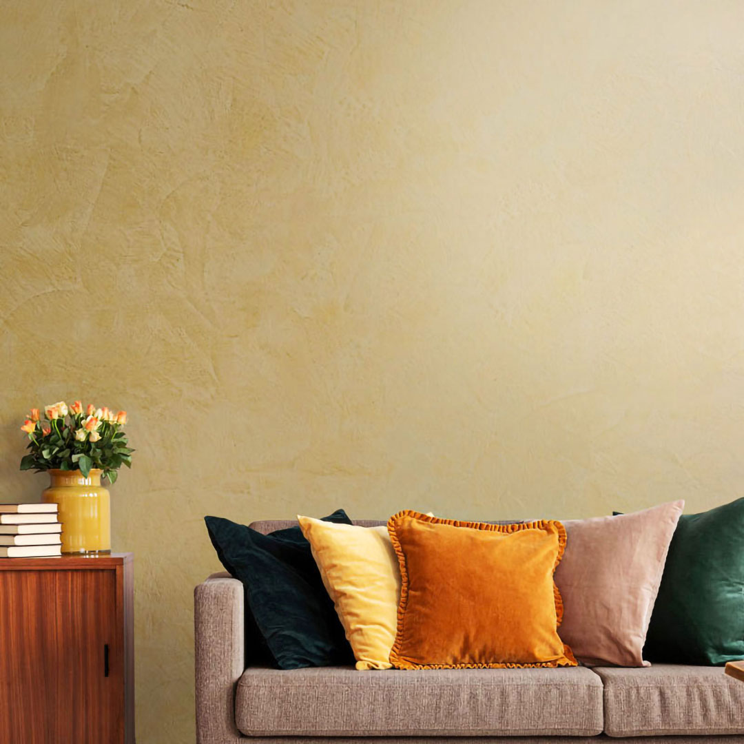 VIOLANTE Rivo Venetian plaster in warm yellow on living room wall with lifestyle styling